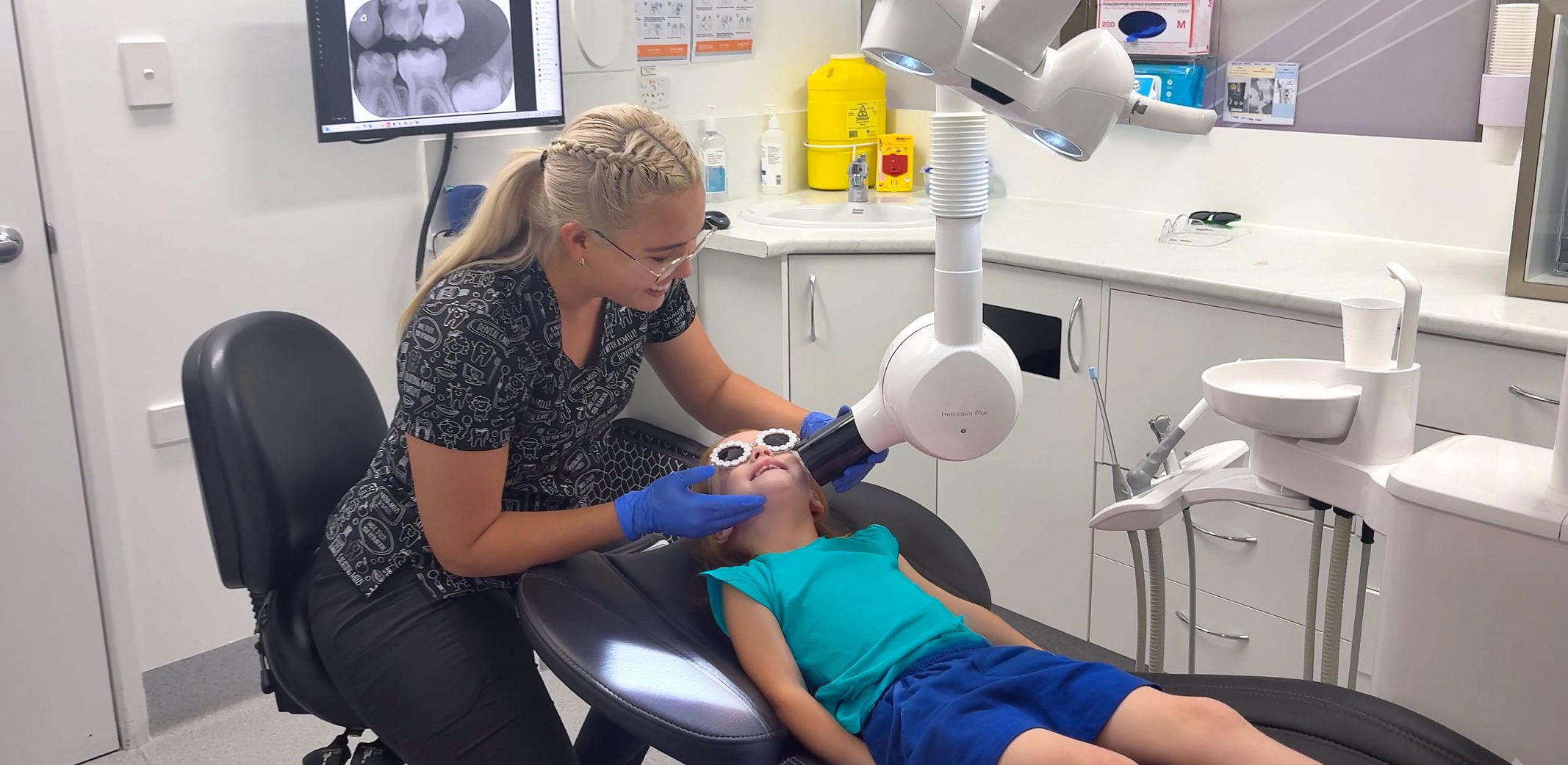 Young girl in dental chair getting an x-ray from the dentist.